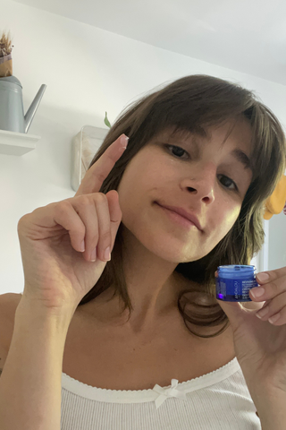 woman shows andalou eye cream texture on her finger