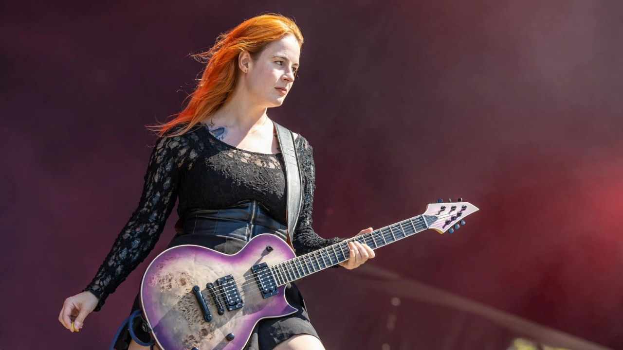 Serena Cherry on stage with her guitar
