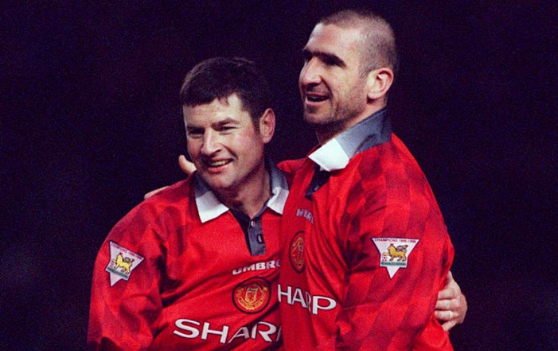 MANCHESTER, ENGLAND - December 21: Denis Irwin of Manchester United and Eric Cantona celebrate during the Premier League match between Manchester United and Sunderland at Old Trafford on December 21, 1996 in Manchester, England. (Photo by Stewart Kendall/Sportsphoto/Allstar via Getty Images)