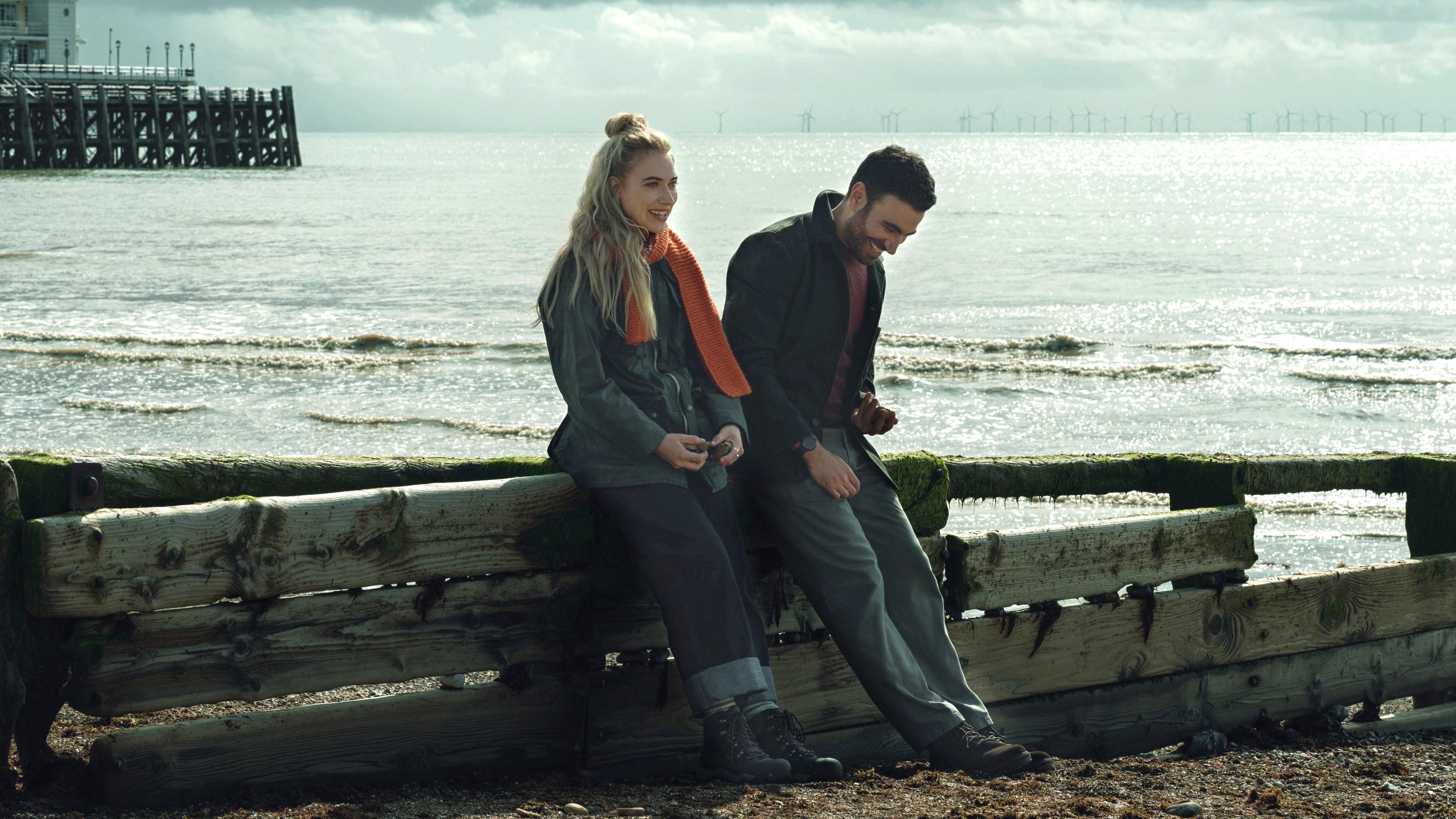 L-R: Imogen Poots and Brett Goldstein lean against a barrier at the beach in a scene from Apple TV Plus&#039; &amp;quot;All Of You&amp;quot;