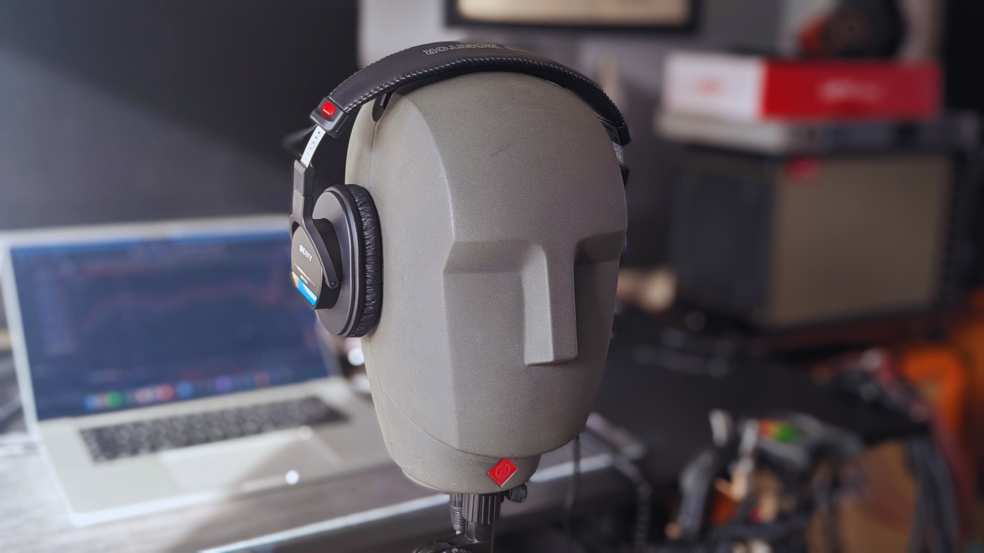 A pair of Sony MDR-7506 studio headphones on a Neumann KU 100 dummy head