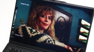 A close up of a laptop display showing an image of a women with blonde hair