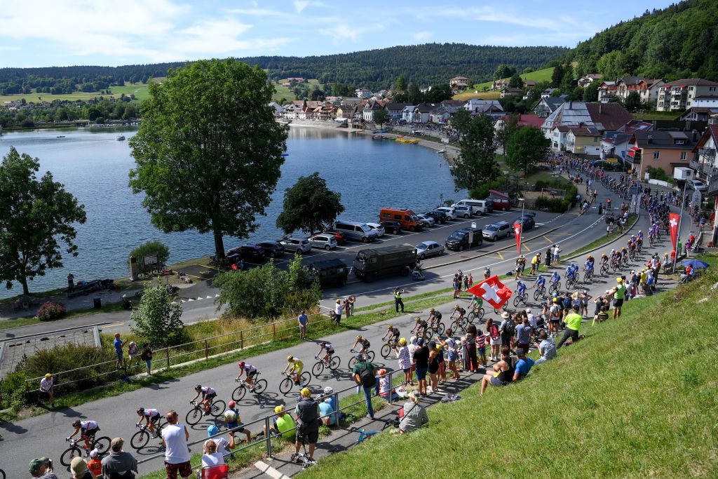 LAUSANNE SWITZERLAND JULY 09 Tadej Pogacar of Slovenia and UAE Team Emirates Yellow Leader Jersey and a general view of the peloton competing during the 109th Tour de France 2022 Stage 8 a 1863km stage from Dole to Lausanne Cte du Stade olympique 602m TDF2022 WorldTour on July 09 2022 in Lausanne Switzerland Photo by Alex BroadwayGetty Images