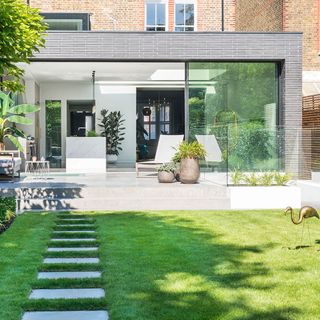 extension house with white wall and garden
