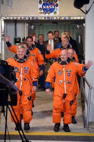 The six astronauts of Endeavour's STS-134 mission - the final flight of NASA's youngest orbiter - depart the Operations & Checkout building at NASA's Kennedy Space Center in Cape Canaveral, Fla. on May 16. The astronauts boarded the "Astro Van" at 5:11 a.m. EDT to journey to Endeavour's seaside Launch Pad 39A.