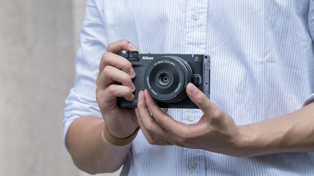 Viltrox AF 26mm F2.8 EVO lens attached to a Nikon camera, in user's hands