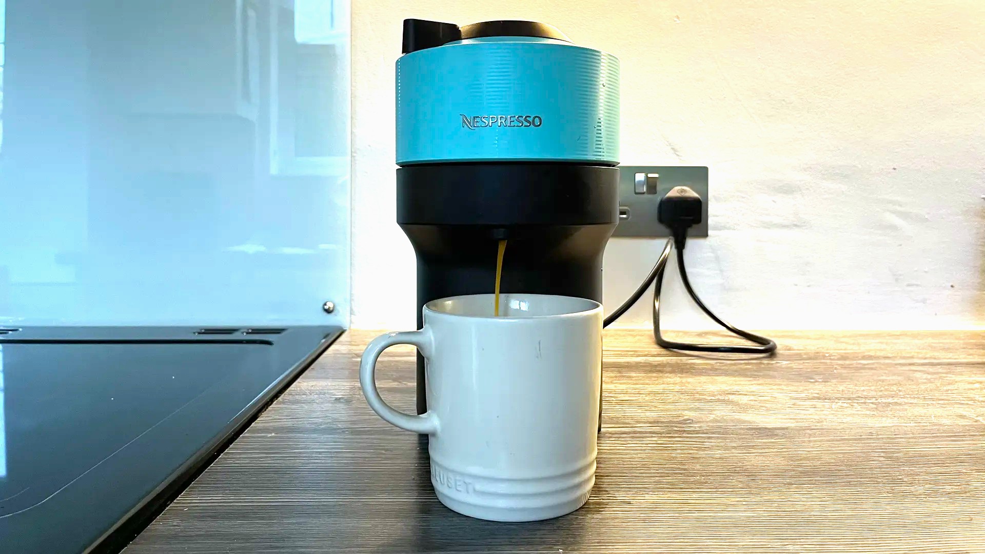 Nespresso Vertuo Pop machine on kitchen counter dispensing coffee