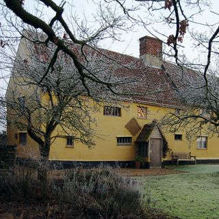 cottage exterior with yellow wall
