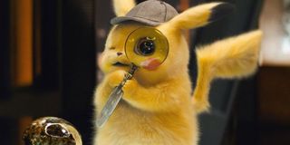 Pokemon Detective Pikachu raising a magnifying glass to its eye