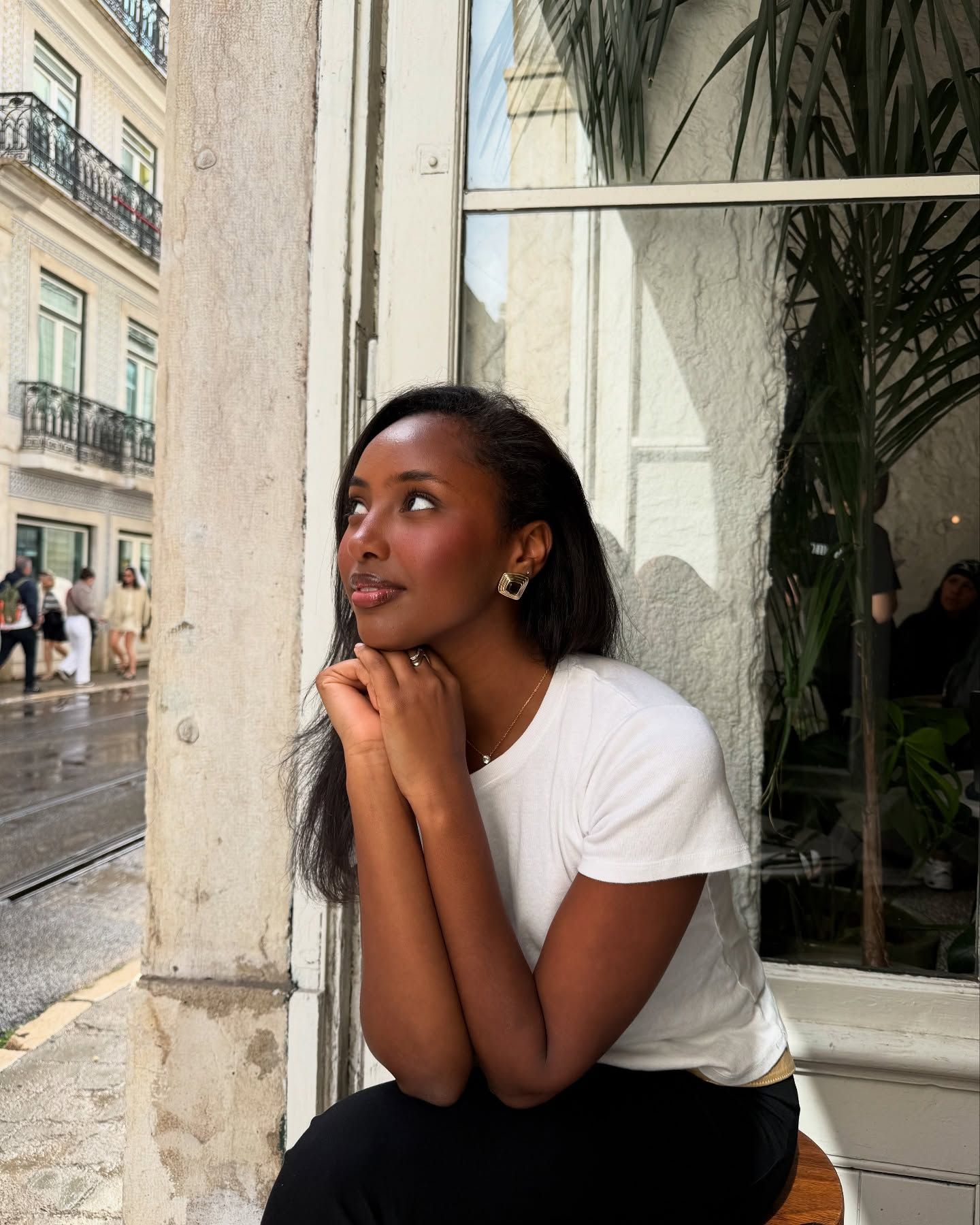 Rayan Xasan is pictured with dewy skin and flushed cheeks in Lisbon, Portugal