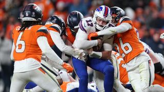 The Bills' Josh Allen running the ball through a forest of Broncos defenders in the NFL Divisional Round