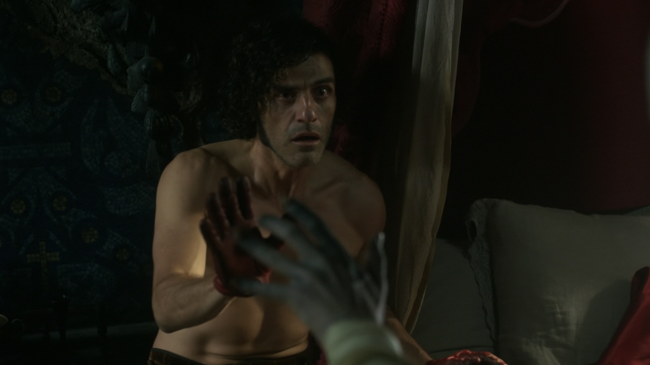 Oscar Isaac reaching for The Creature in Frankenstein
