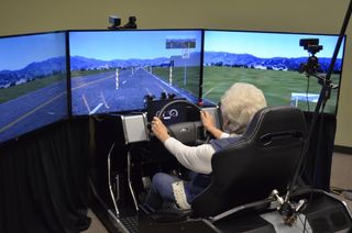 A study participant sits in the high-fidelity driving simulator.