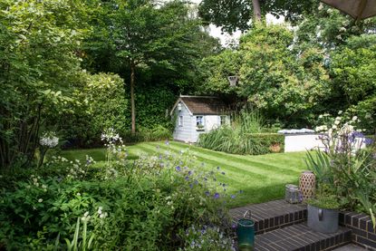 kids garden with lawn and playhouse