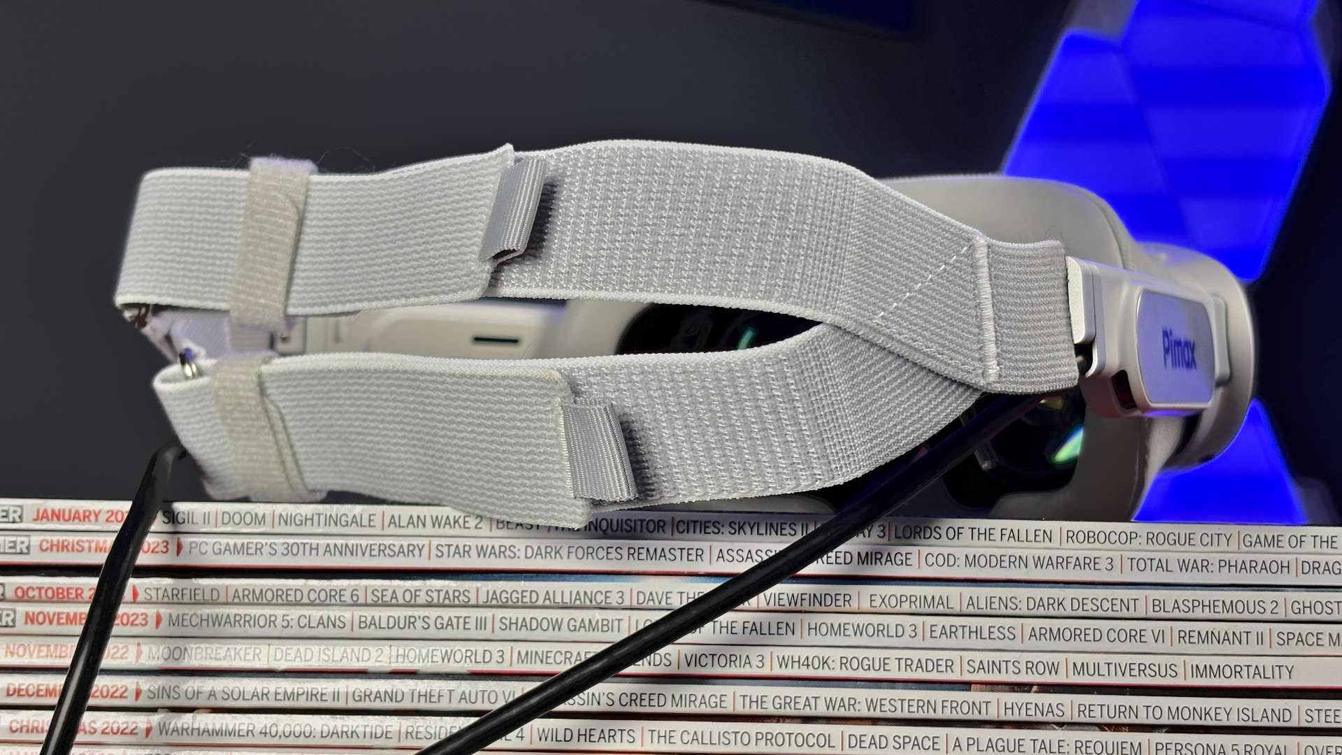 The Pimax Dream Air in white on a stack of PC Gamer magazine.
