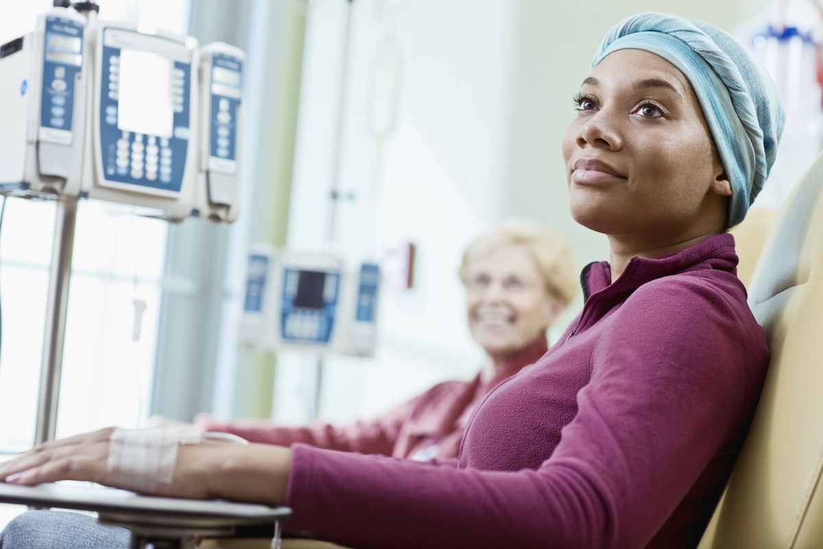 A woman receiving intravenous chemotherapy treatment.