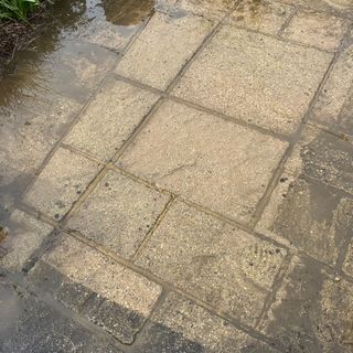 Pressure washer testing on patio, wood and a car