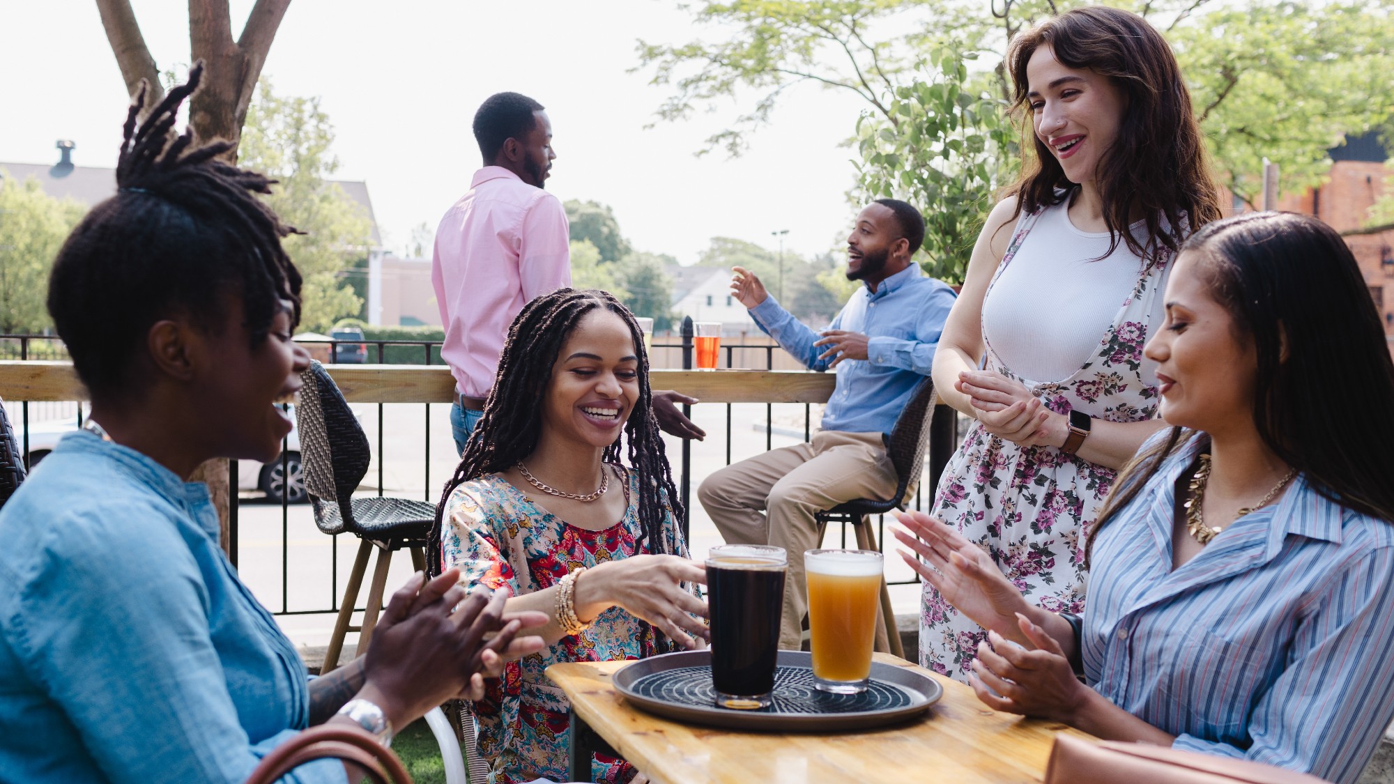 Group of friends having drinks at an outdoor bar