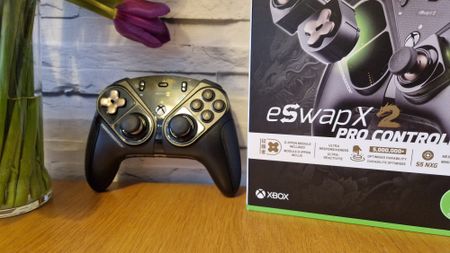 The Thrustmaster eSwap X2 controller on a wooden surface