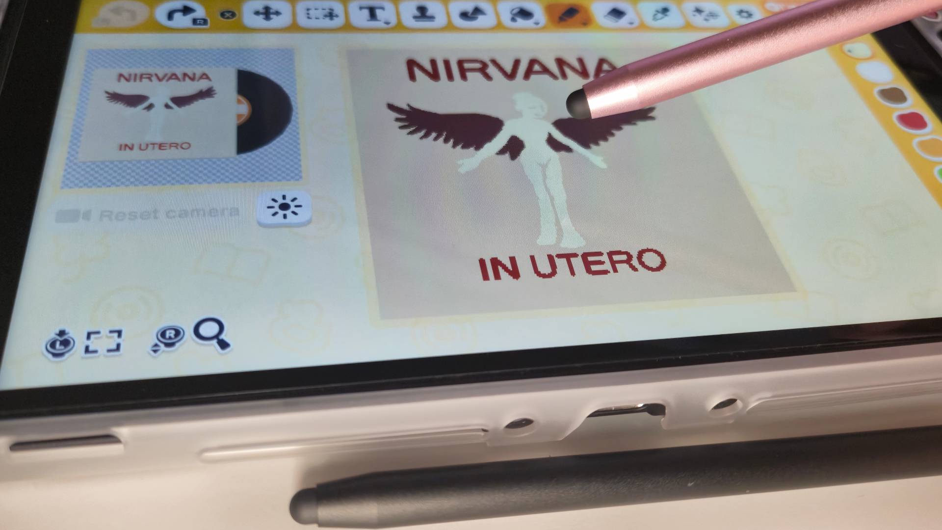 Photo of a rose gold stylus pen resting on the display of a Nintendo Switch 2.
