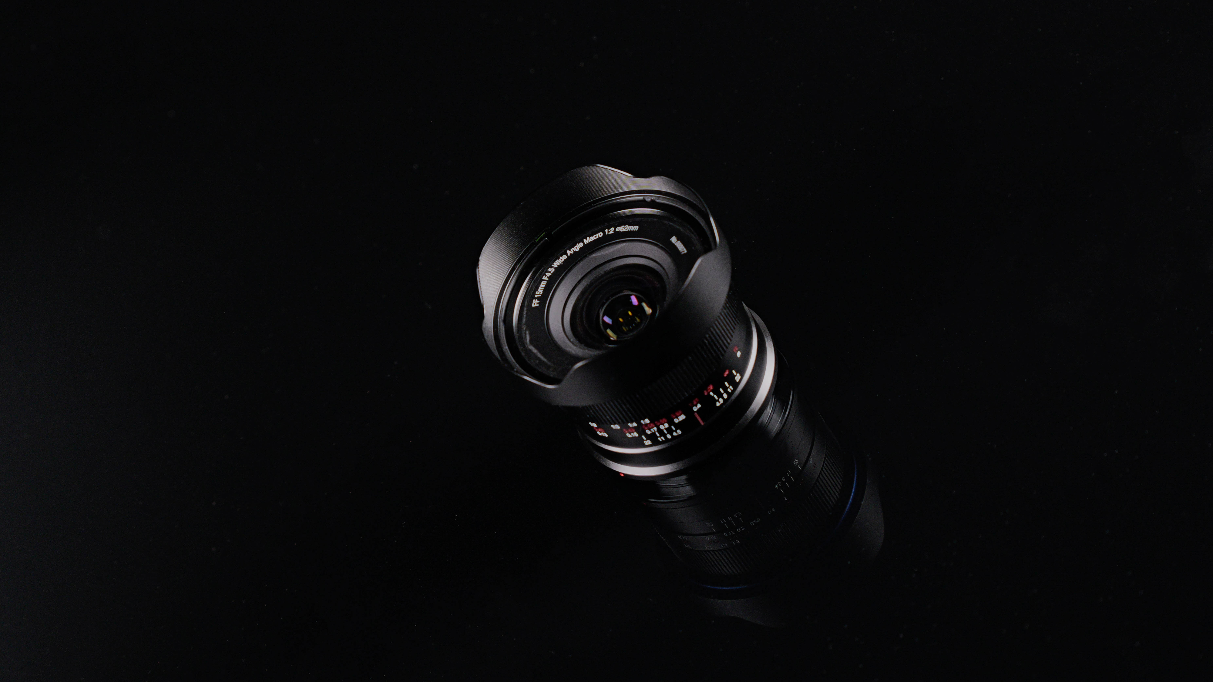 The Laowa 15mm f/4.5 0.5x Wide Angle Macro lens on a black background