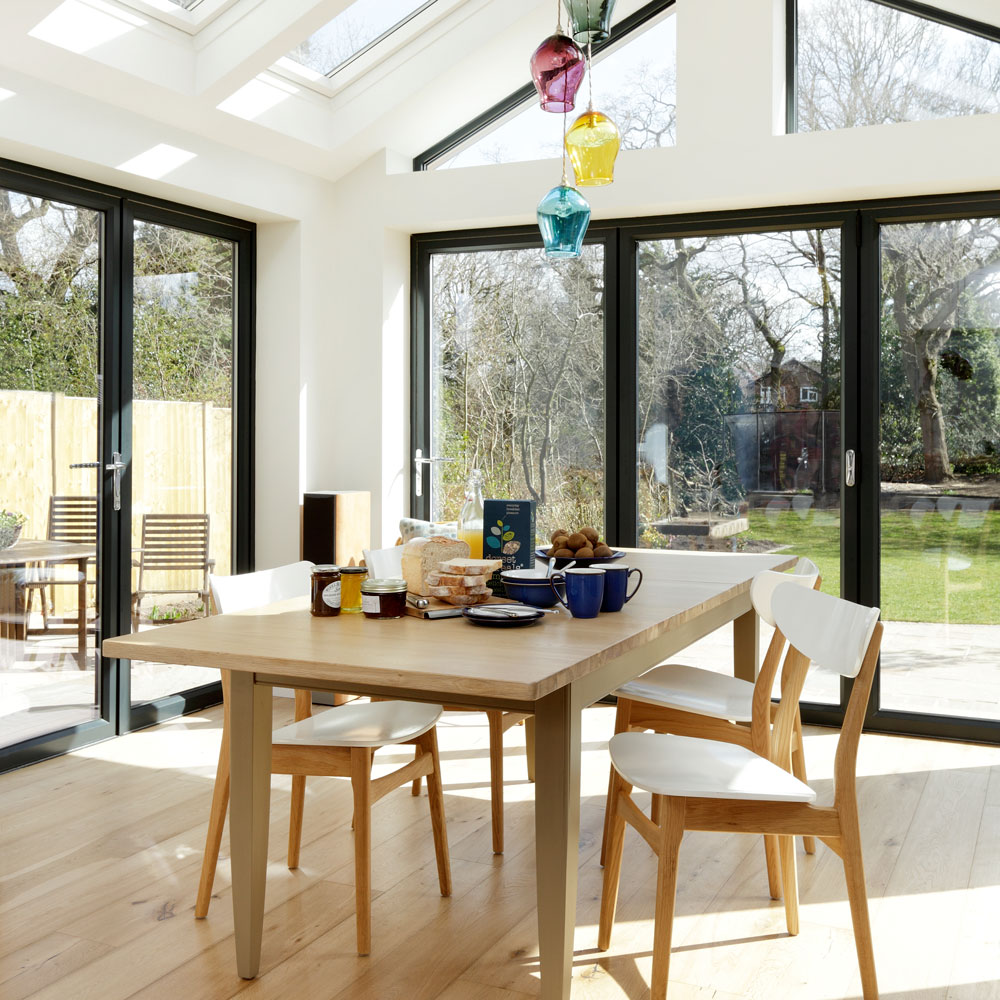 inside single storey glass conservatory extension with doors and windows with black frames