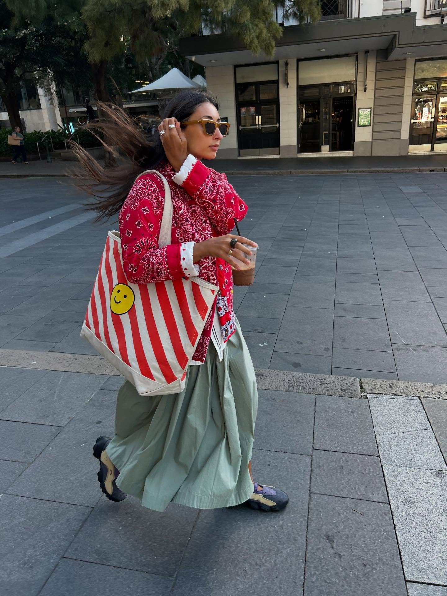 Dated summer shoe trends 2026: Barbara Santiago wears a red jacket, maxi skirt and gorpcore shoes