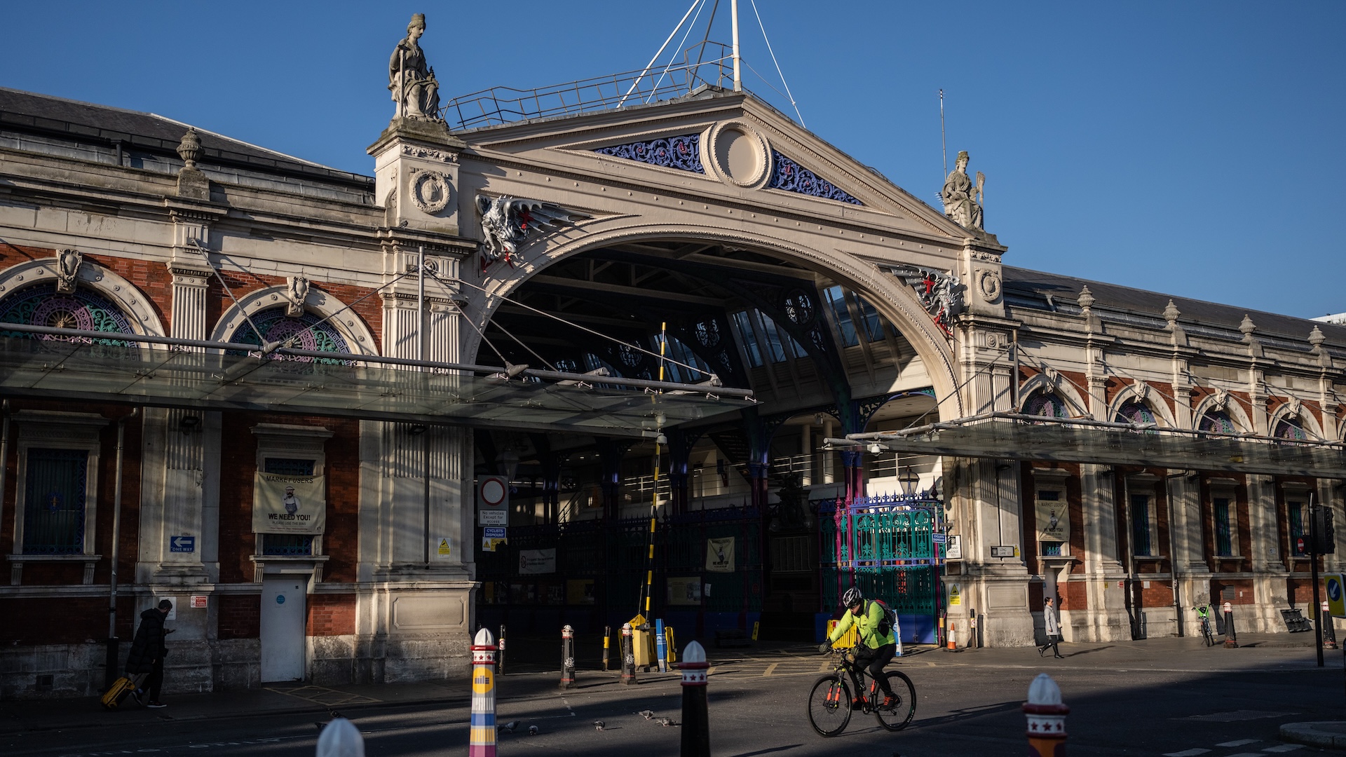 LONDON, ENGLAND - FEBRUARY 13: A cyclist passes Smithfield Market on February 13, 2023 in London, England. Central London's Smithfield meat market, which dates from the 10th century, will relocate to a purpose-built site in Dagenham as part of a 1 billion GBP project to combine the city's wholesale markets under one roof. The vacated area will house the re-located Museum of London. The move from Smithfield faced opposition from meat traders, who had threatened to invoke a royal charter to remain at the site. However, the new market is expected to bring 2,700 new jobs to the borough of Barking and Dagenham. (Photo by Carl Court/Getty Images)