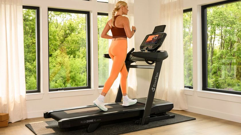 Woman running on the Bowflex T16 treadmill in spacious home