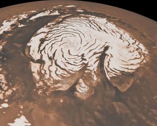 as seen from above, a swirling pattern takes shape across the ice cap at Mars' north pole