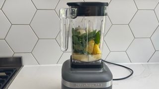 KitchenAid K150 blender filled with fruit ready to make a smoothie