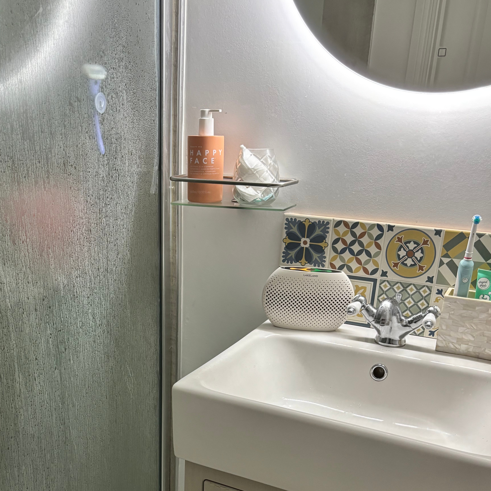 The Lakeland small dehumidifier in a bathroom with condensation and steam on shower glass