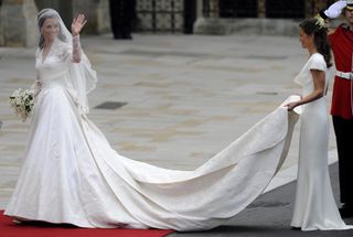 Kate Middleton waves as she arrives at the West Door of Westminster Abbey in London for her wedding to Britain's Prince William, on April 29, 2011