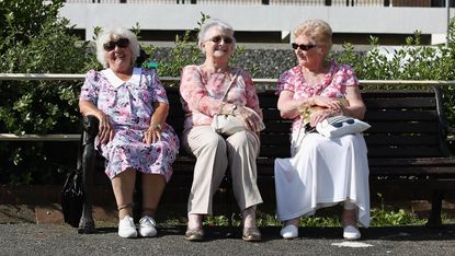 Eldery ladies share a joke on a bench in Worthing