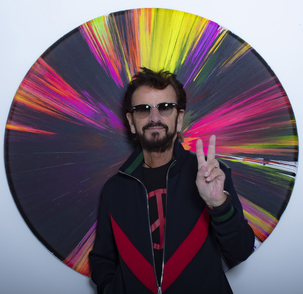 Ringo Starr art; a man in front of a circular colourful painting