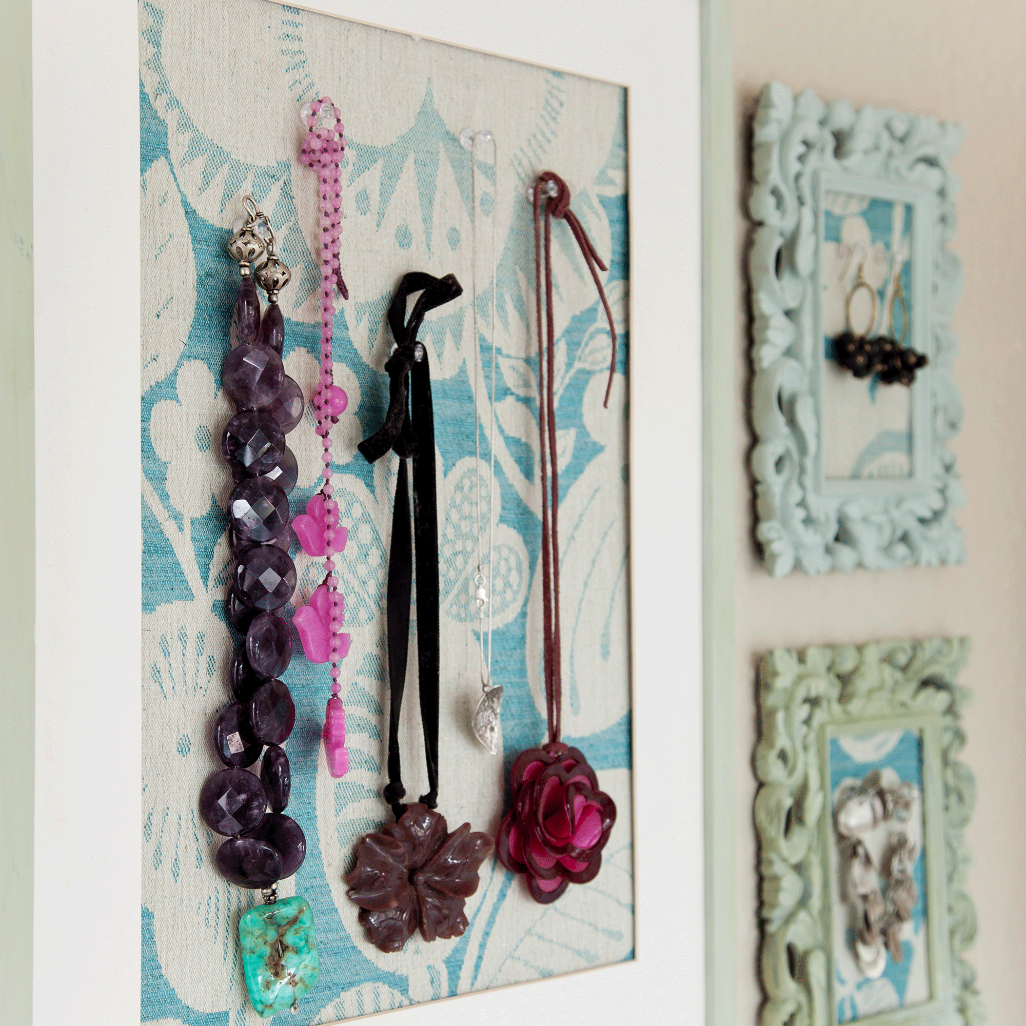 Necklaces hung in frames