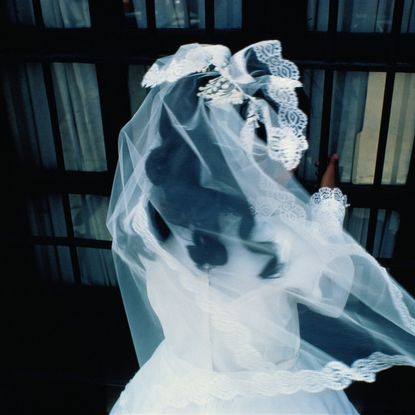 Mexico, Oaxaca, girl attending communion, rear view