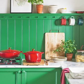 Kitchen with bright green cabinets and panelled splashback