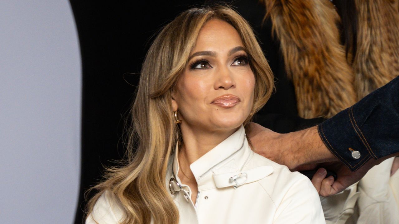 Jennifer Lopez attends a Broadway show wearing a drapey white wrap suit to a showing of Oh Mary