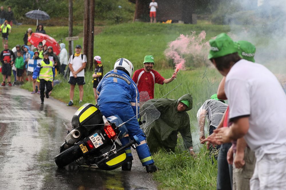 A moto had trouble in the rain during stage 20 at the Tour de France.