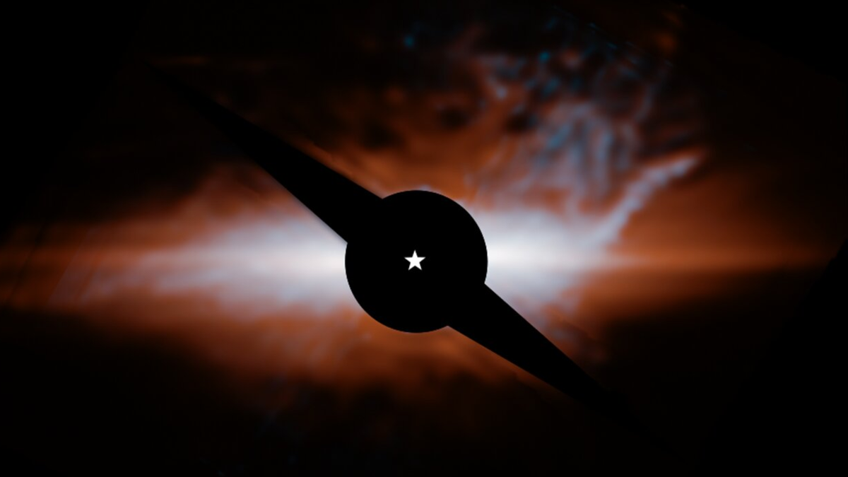 photo showing a large, reddish-orange dust cloud in deep space.