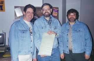 Younger Rawitsch, Heinemman and Dillenberger holding a page of The Oregon Trail source code. Image via Citypages.com.