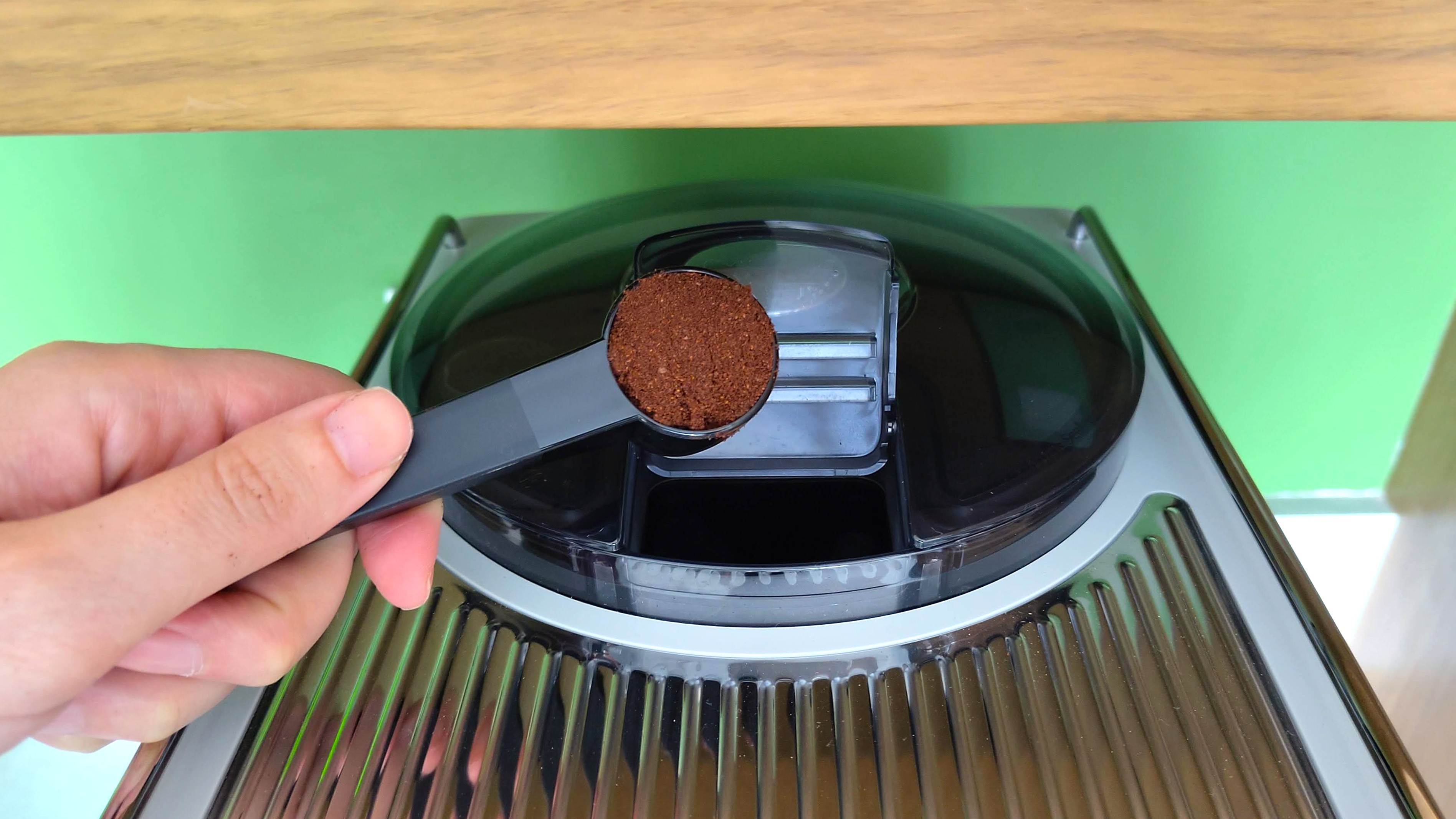 Adding a scoop of pre-ground coffee to Philips Cafe Aromis Series 8000 coffee maker