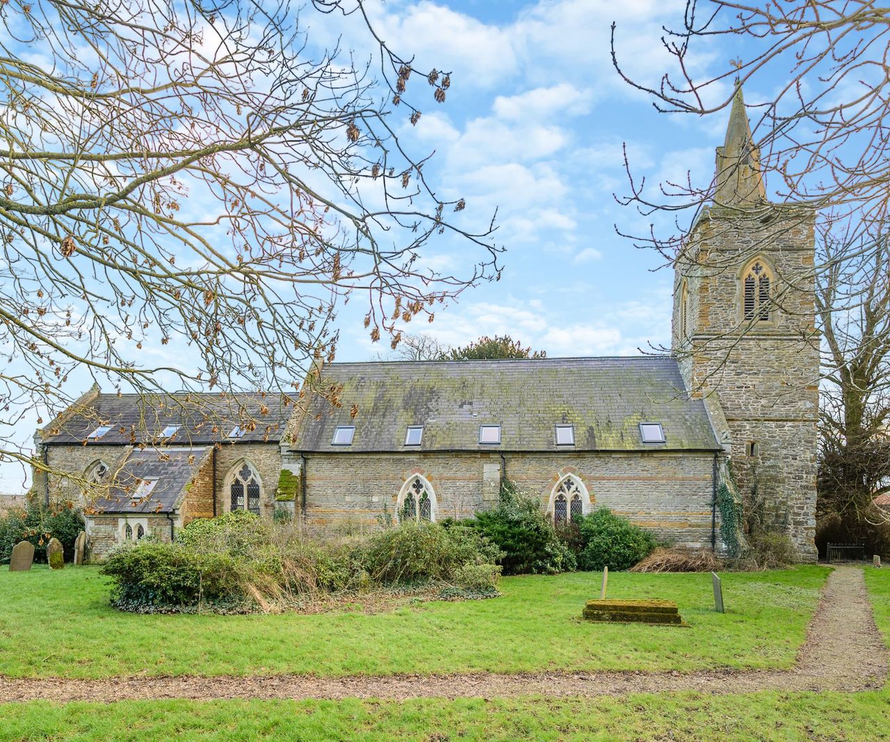 The exterior of a converted church with its grounds