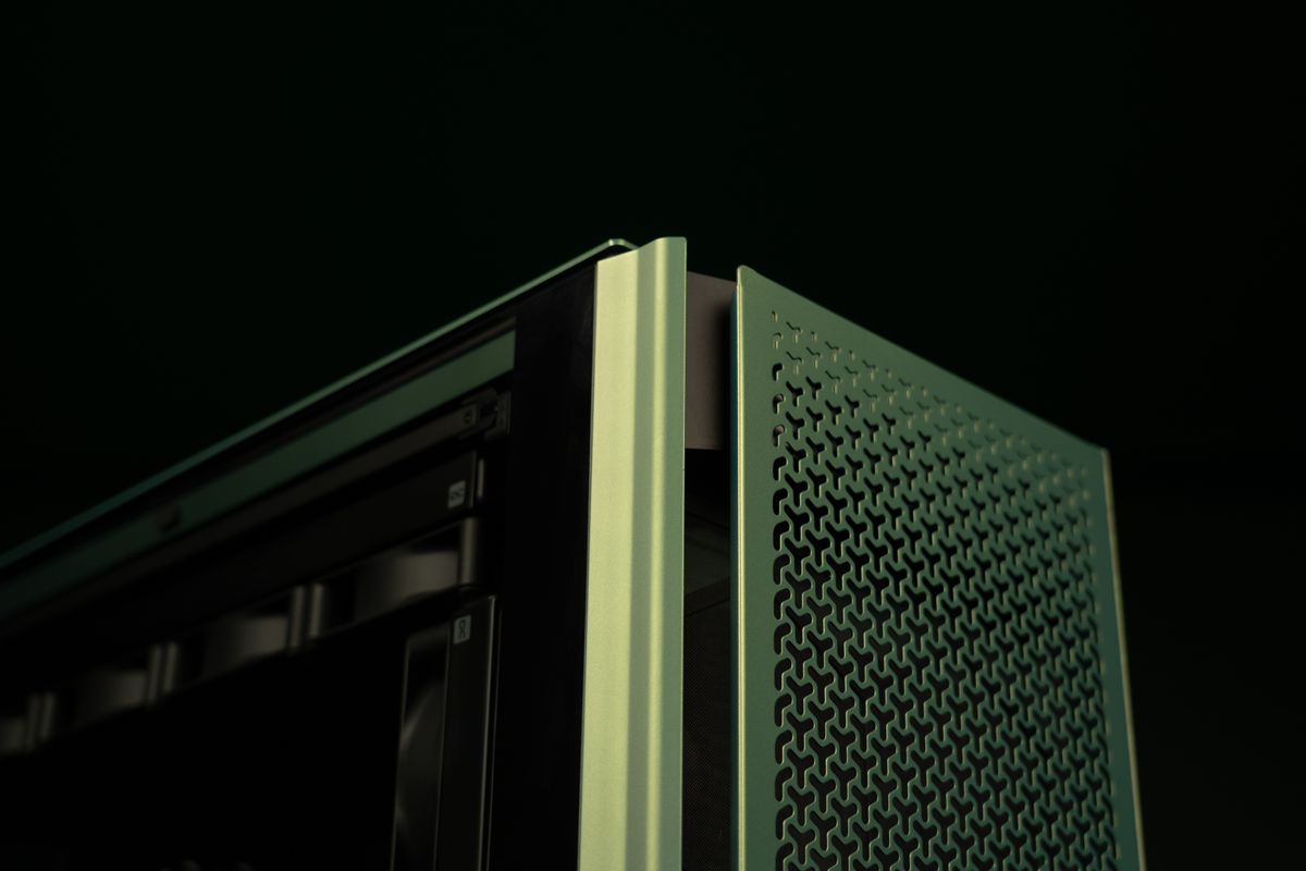 A PC gaming rig designed by Aston Martin, green with wood pannelling