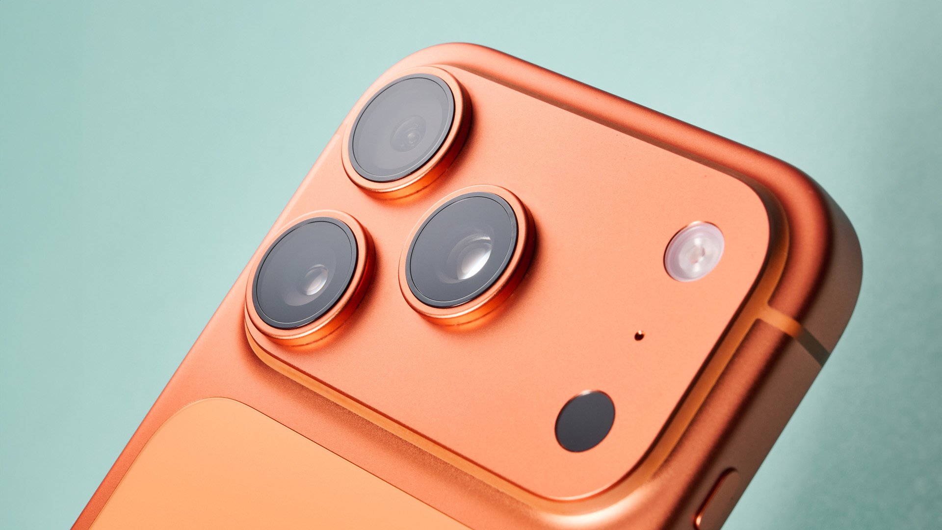 Apple iPhone 17 Pro in cosmic orange on green background
