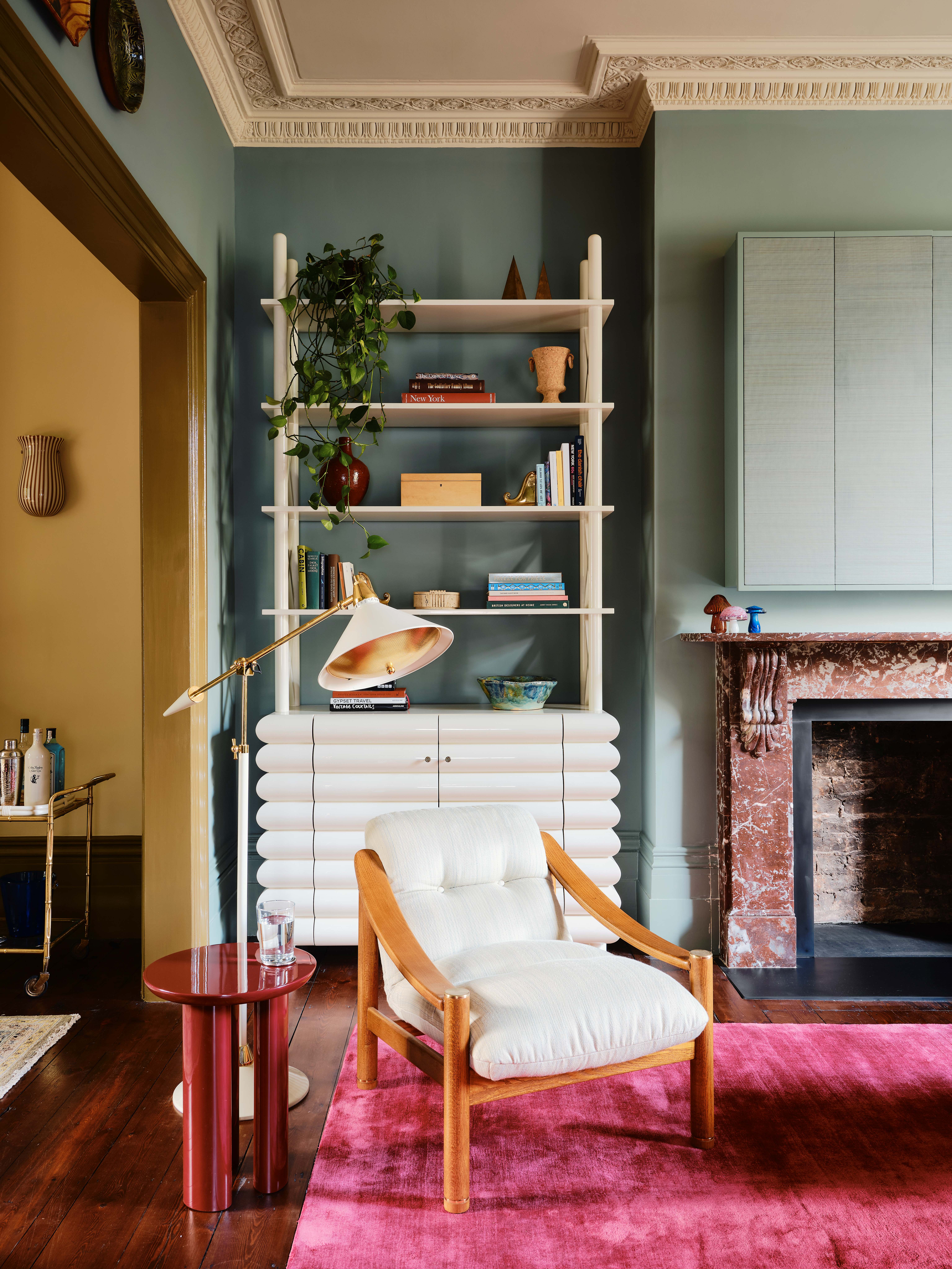 Light blue living room with hot pink rug by Studio Duggan