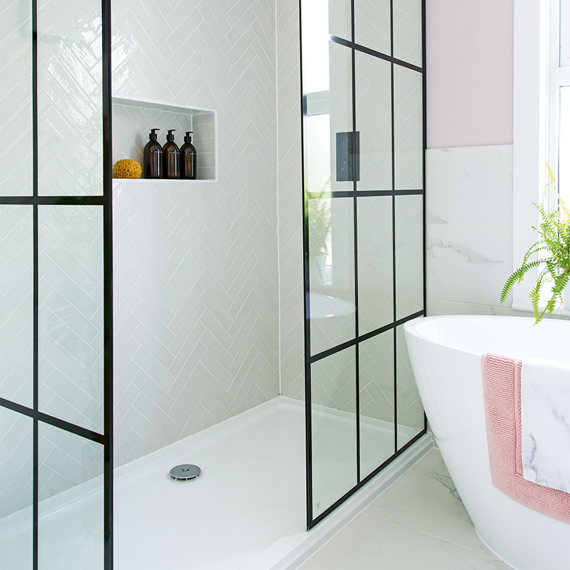 Pink bathroom with walk in shower with black crittal shower screen