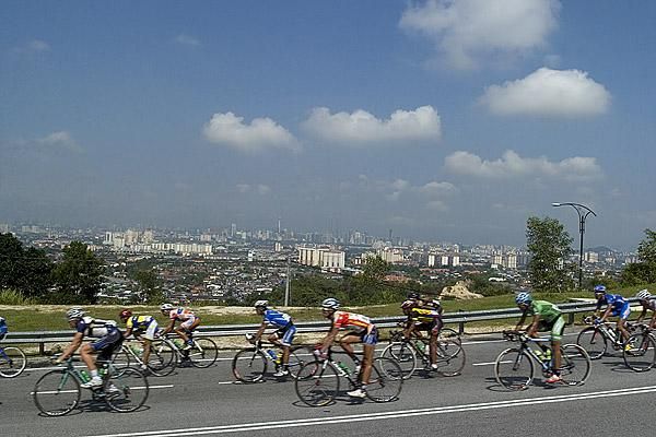 Riders descend a climb with the Malaysian capital Kuala Lumpur in the background.