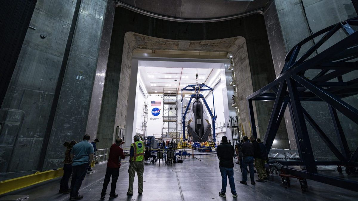 a winged space plane with folded wings in a hangar